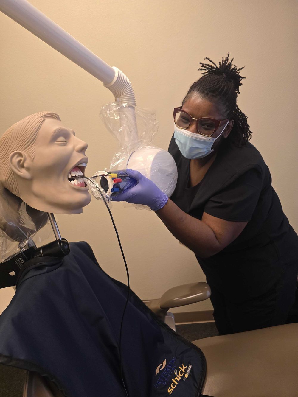 dental assistant student training to capture X-rays